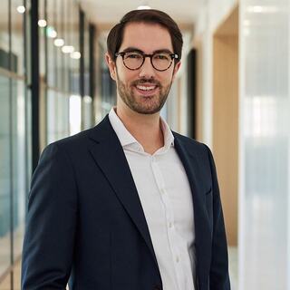 man standing with glasses